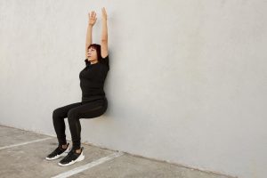 woman doing wall stand excercise